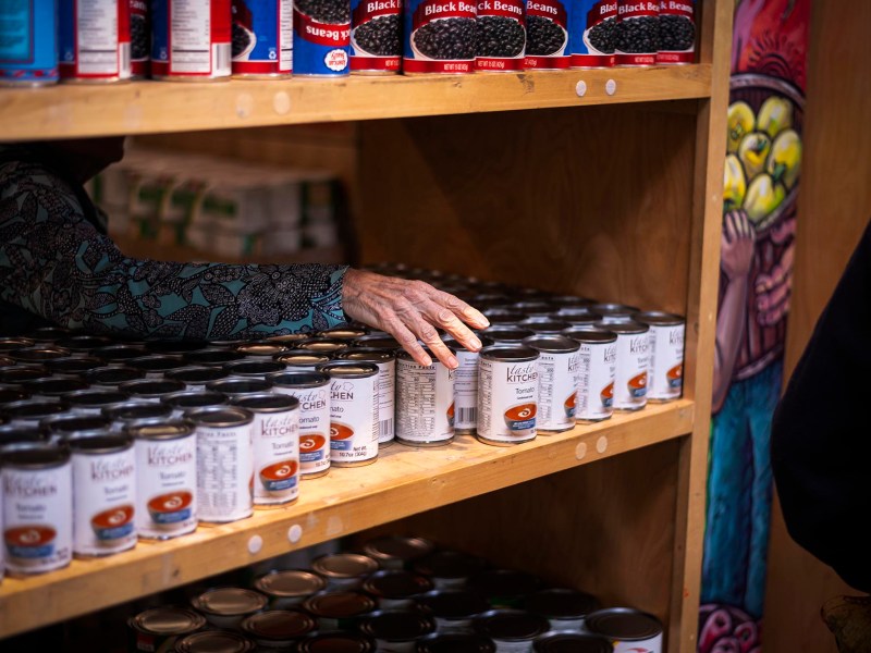 A shelf full of cans in a store.