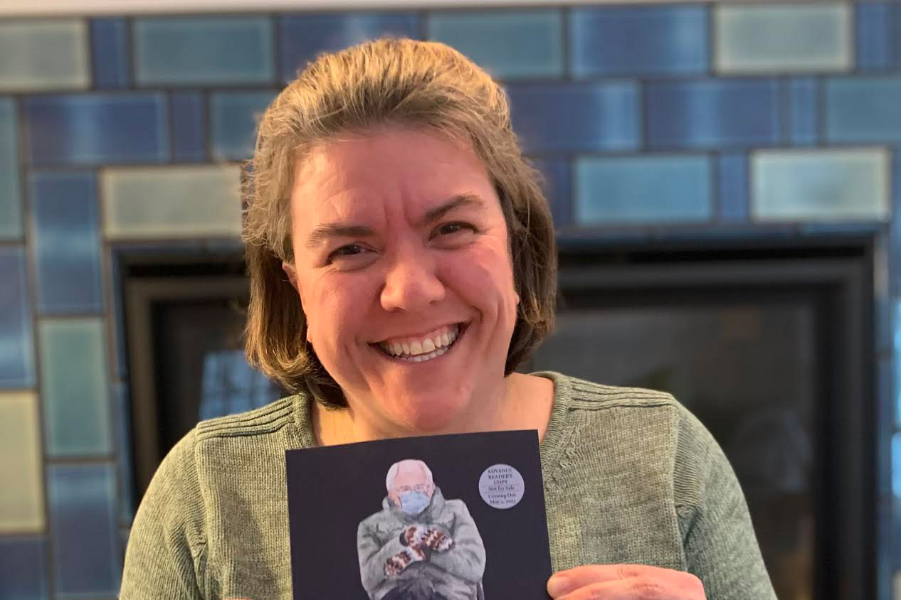 a woman holding up a book