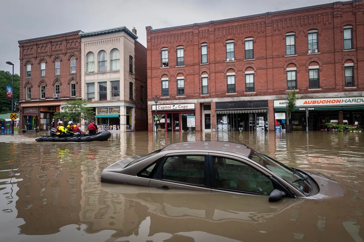 a car is stranded in a flooded street.