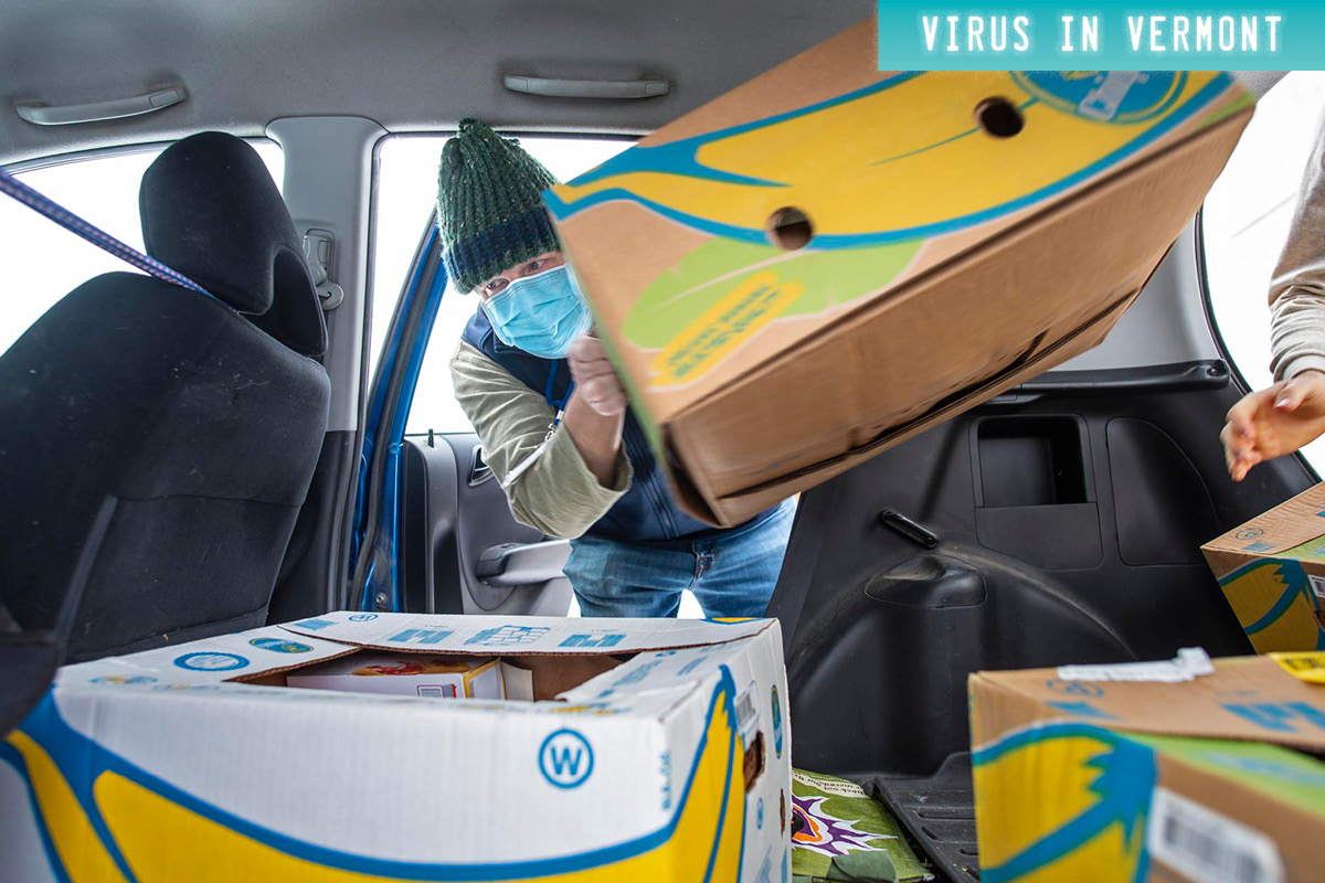man loading banana boxes into car