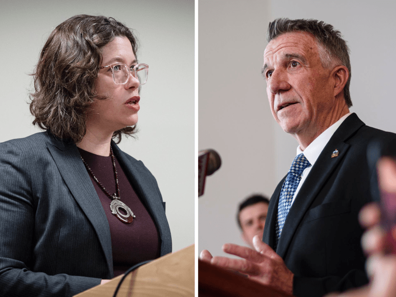 A woman in a dark blazer speaks at a podium on the left; a man in a suit and tie speaks at a podium on the right.